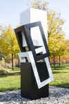 This abstract sculpture, which can be installed indoors or outdoors, is painted in a striking black and white. Image 2