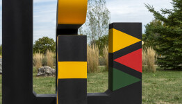 This contemporary abstract outdoor painted steel sculpture is figurative. Image 8
