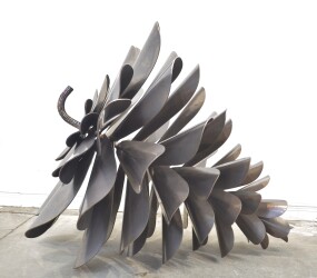 This contemporary sculpture of a pine cone is made from metal by Floyd Elzinga.