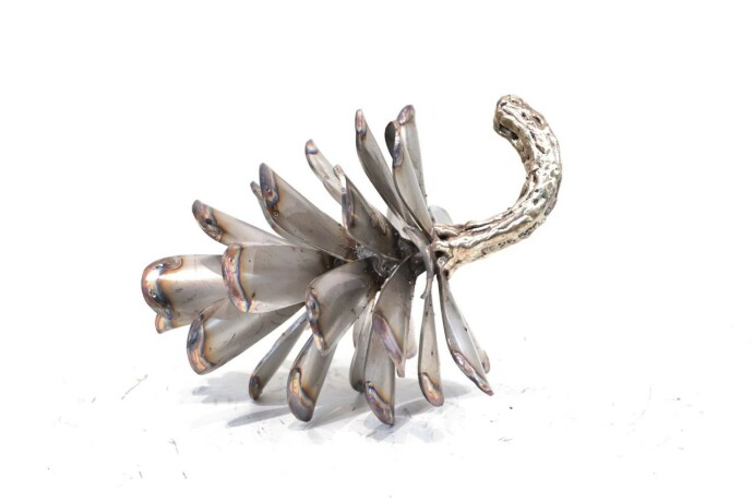 This contemporary table top metal sculpture of a pine cone is by Floyd Elzinga.