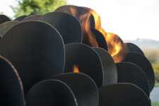 This contemporary outdoor steel sculpture of a pine cone by Floyd Elzinga is also wood-burning. Image 7