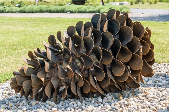 This large outdoor pop art sculpture was hand-forged in steel; its form was inspired by nature.