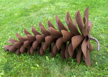 This contemporary outdoor sculpture was forged from steel; its form is inspired by nature. Image 2