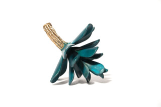 The deep turquoise colour of this small tabletop sculpture by Floyd Elzinga enhances its iconic form.