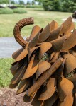 Hand forged from weathering steel Floyd Elzinga’s impressive outdoor sculpture of a pine cone is designed to house logs for a fire. Image 4