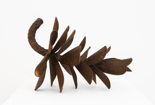 This contemporary table top metal sculpture of a pine cone is by Floyd Elzinga.