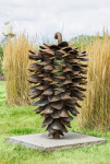 This contemporary outdoor sculpture of a pine cone made from steel is by Floyd Elzinga. Image 3