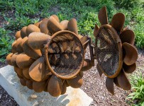 Hand forged from weathering steel Floyd Elzinga’s impressive outdoor sculpture of a pine cone is designed to house logs for a fire. Image 11
