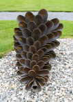 This contemporary outdoor sculpture was forged from steel; its form is inspired by nature. Image 2