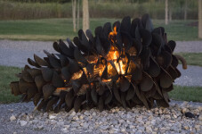 This contemporary outdoor steel sculpture of a pine cone by Floyd Elzinga is also wood-burning. Image 3