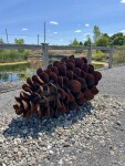 This contemporary outdoor steel sculpture of a pine cone by Floyd Elzinga is also wood-burning. Image 8