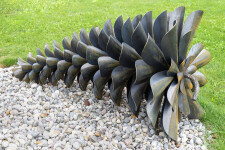 This contemporary outdoor sculpture was forged from steel; its form is inspired by nature. Image 3