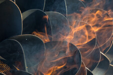 This contemporary outdoor steel sculpture of a pine cone by Floyd Elzinga is also wood-burning. Image 5