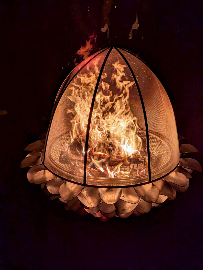 This contemporary outdoor metal sculpture of an acorn by Floyd Elzinga can also burn wood.