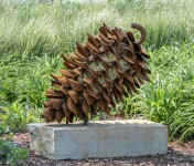 Hand forged from weathering steel Floyd Elzinga’s impressive outdoor sculpture of a pine cone is designed to house logs for a fire. Image 5