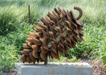 Hand forged from weathering steel Floyd Elzinga’s impressive outdoor sculpture of a pine cone is designed to house logs for a fire. Image 4