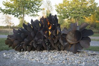 This large outdoor pop art sculpture was hand-forged in steel; its form was inspired by nature.