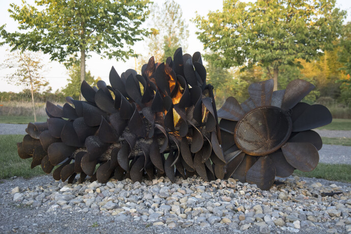 This large outdoor pop art sculpture was hand-forged in steel; its form was inspired by nature.