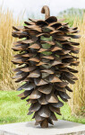 This contemporary outdoor sculpture of a pine cone made from steel is by Floyd Elzinga. Image 4