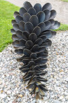 This contemporary outdoor sculpture was forged from steel; its form is inspired by nature. Image 2