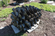 This contemporary outdoor steel sculpture of a pine cone by Floyd Elzinga is also wood-burning. Image 3
