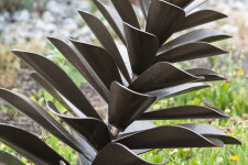 This contemporary outdoor sculpture of a pine cone is made from metal by Floyd Elzinga. Image 3