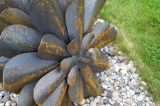 This contemporary outdoor sculpture was forged from steel; its form is inspired by nature. Image 4