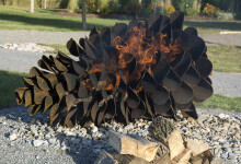 This contemporary outdoor steel sculpture of a pine cone by Floyd Elzinga is also wood-burning. Image 9