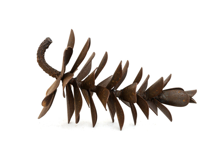 This contemporary table top steel sculpture of a pine cone is by Floyd Elzinga.