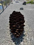 This contemporary outdoor steel sculpture of a pine cone by Floyd Elzinga is also wood-burning. Image 2