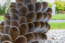 This contemporary outdoor sculpture was forged from steel; its form is inspired by nature. Image 3