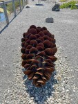 This contemporary outdoor steel sculpture of a pine cone by Floyd Elzinga is also wood-burning. Image 7