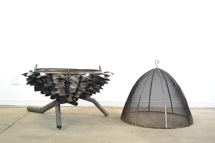 This contemporary outdoor metal sculpture of an acorn by Floyd Elzinga can also burn wood.