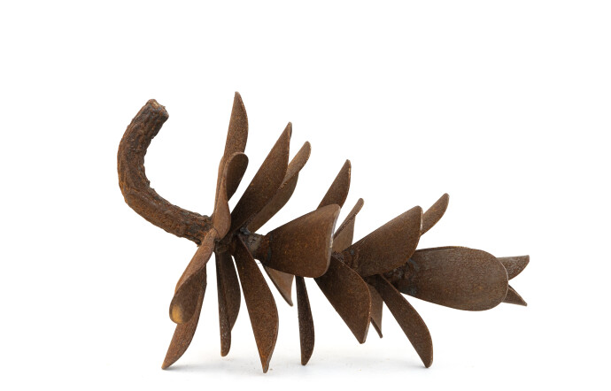 This contemporary table top steel sculpture of a pine cone is by Floyd Elzinga.