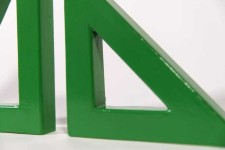 Two striking triangles in bright apple green steel; their center cut-out triangles stand beside one another in this new tabletop sculpture b… Image 4