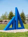 Two striking steel triangles painted in royal blue—in different sizes; their centers cut-out triangles stand beside one another in this new … Image 3