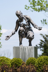 This sculpture portrays a woman gazing towards earth beneath her, crafted with a reconstructive approach.