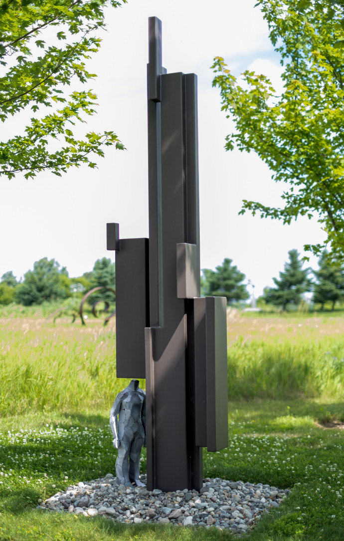 This contemporary outdoor sculpture was forged from steel in a figurative and geometric form.