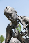 This sculpture portrays a woman gazing towards earth beneath her, crafted with a reconstructive approach. Image 5