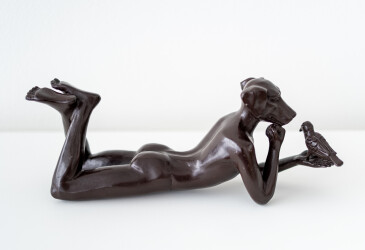 This contemporary figurative bronze tabletop sculpture featuring a dogman is by Gillie and Marc.