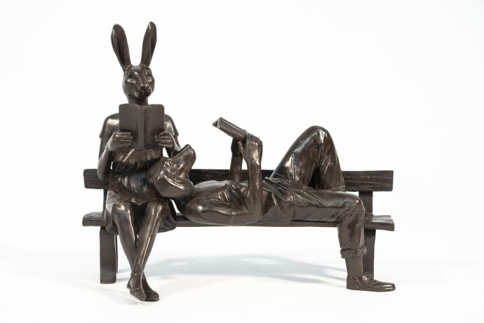 Captured reading books, this contemporary bronze figurative sculpture is by Gillie and Marc.