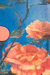 Lush stems of gorgeous coral-coloured roses play against a deep blue and white background. Image 6