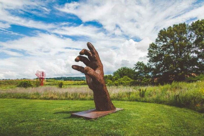 A massive hand appears to rise out of the earth in this engaging sculpture by Mississippi artist, Jason Kimes.