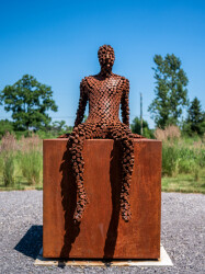 This figurative outdoor sculpture is forged from steel.