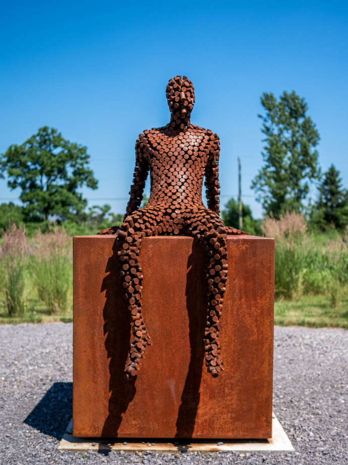 This figurative outdoor sculpture is forged from steel.