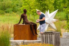 A seated figure reclines atop a steel cube in this intriguing work by Mississippi sculptor Jason Kimes. Image 3