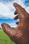 A massive hand appears to rise out of the earth in this engaging sculpture by Mississippi artist, Jason Kimes. Image 4