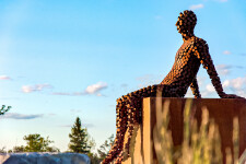 This figurative outdoor sculpture is forged from steel. Image 2