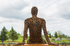 This figurative outdoor sculpture is forged from steel. Image 9