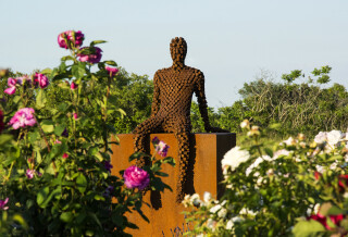 This figurative outdoor sculpture is forged from steel.
